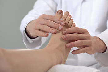 Doctor holding patients foot